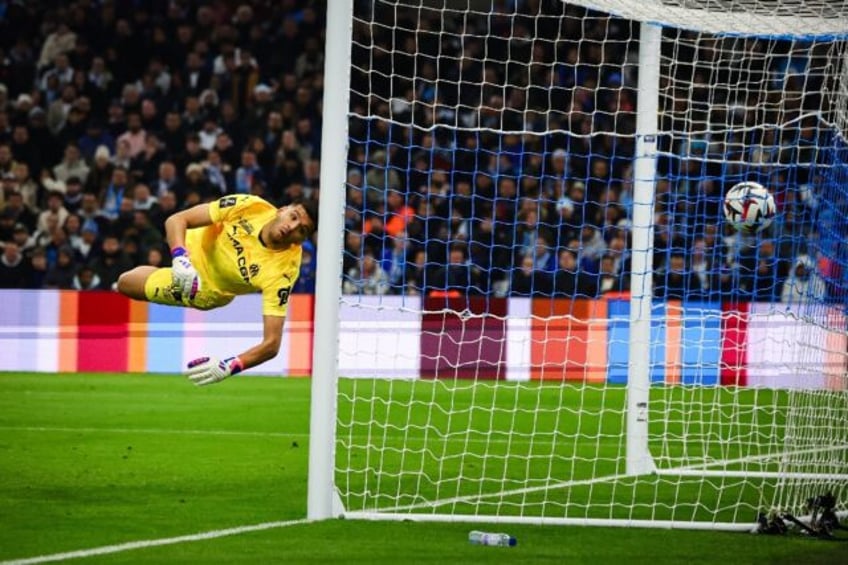 Marseille goalkeeper Geronimo Rulli watches Lille's leveller fly past him