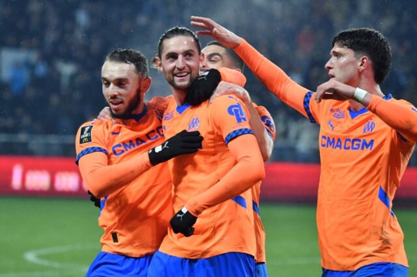 Adrien Rabiot (CL) celebrates with teammates after scoring Marseille's first goal in their