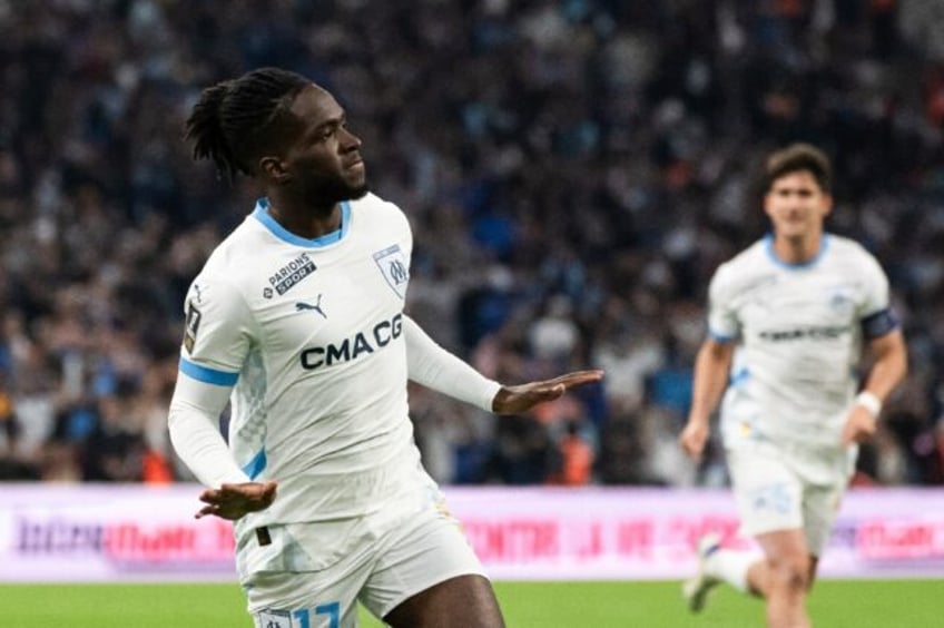 Jonathan Rowe (C) celebrates after giving Marseille the lead against Angers