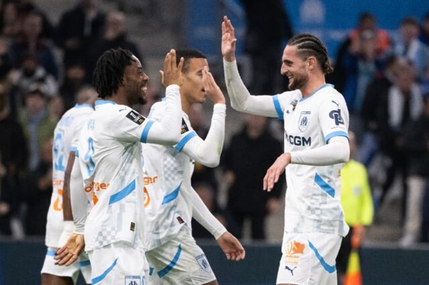 Elye Wahi (L) celebrates with Adrien Rabiot after scoring Marseille's fourth goal in their