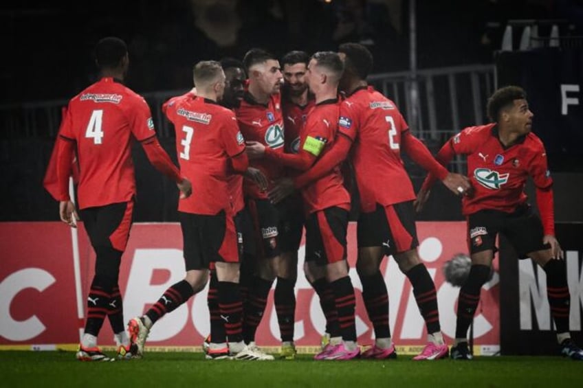 Star man: Rennes Martin Terrier and his teammates celebrate his equaliser against Marseille