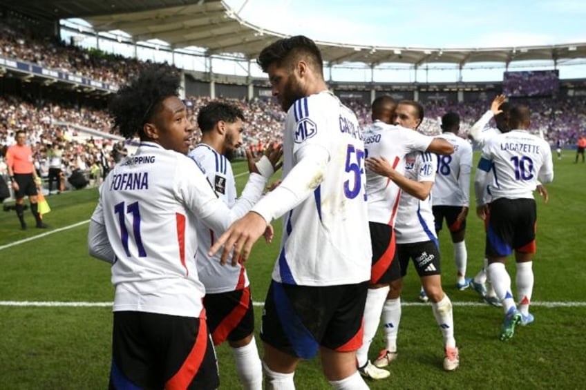 Malick Fofana (L) celebrates his winner for Lyon at Toulouse