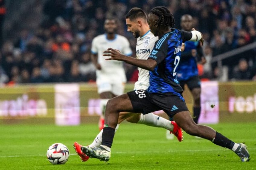 Marseille's Neal Maupay (C) takes on Ismael Doukoure of Strasbourg in Sunday's 1-1 draw