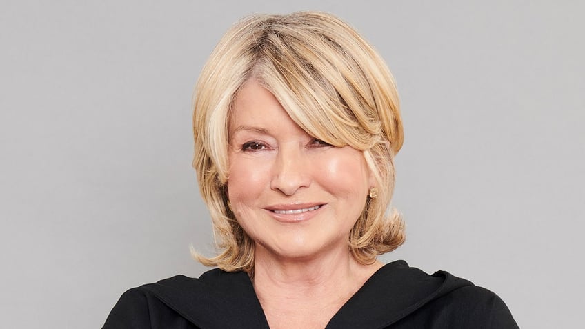 Martha Stewart smiles wearing black jumpsuit