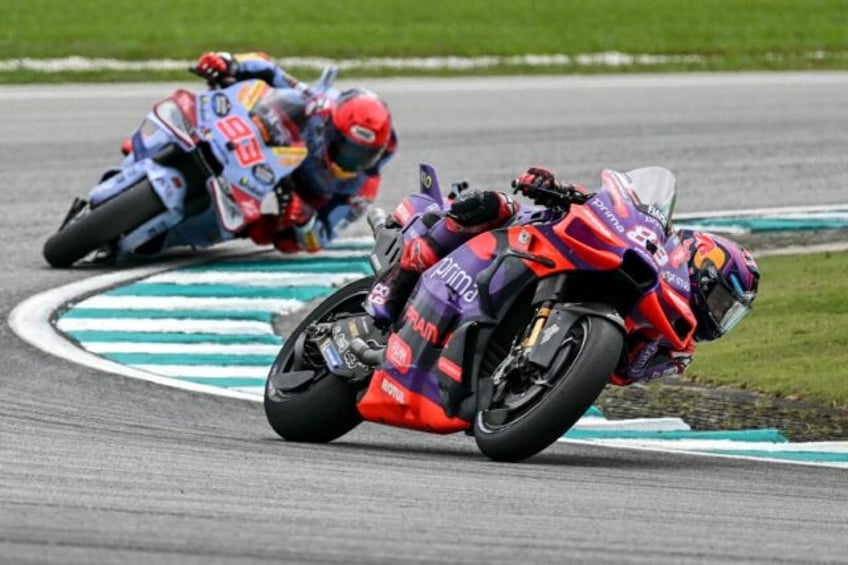 Jorge Martin leads Marc Marquez through a turn in the sprint race at Sepang