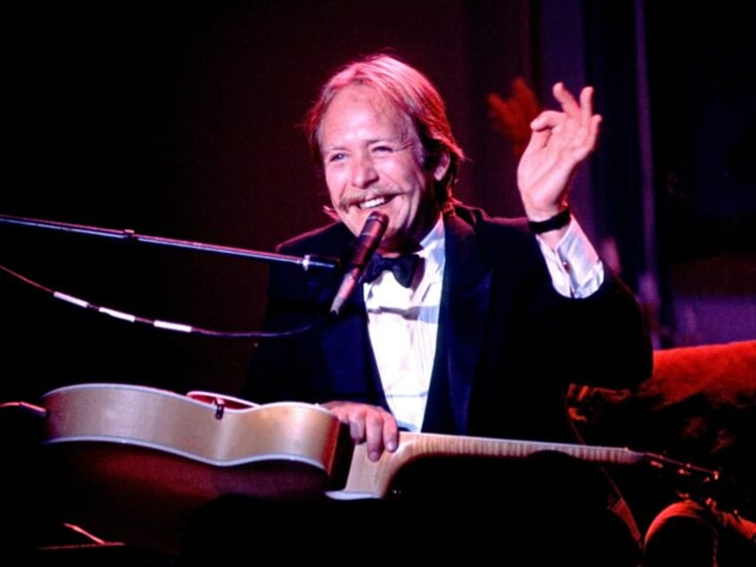 Comedian Martin Mull plays guitar as he performs onstage, Chicago, Illinois, July 26, 1980