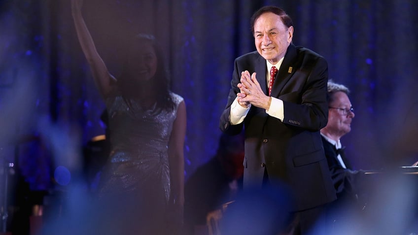 Richard M. Sherman clapping on stage