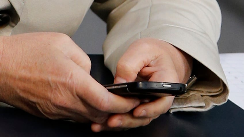 FILE: UNDATED: A person sends an email on a smartphone.