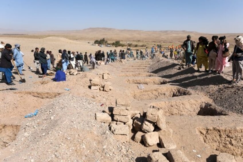 mass funeral held for afghan quake victims families still missing