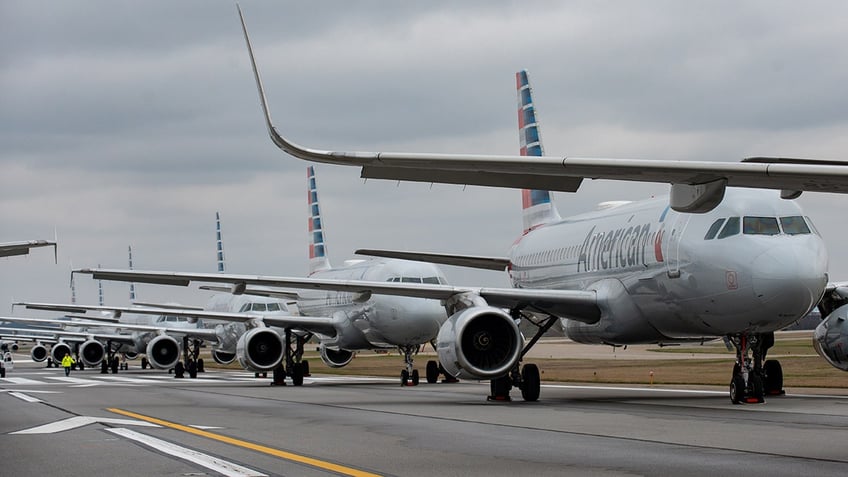 massachusetts troopers and fbi agents respond to american airlines flight in boston for reported criminal act