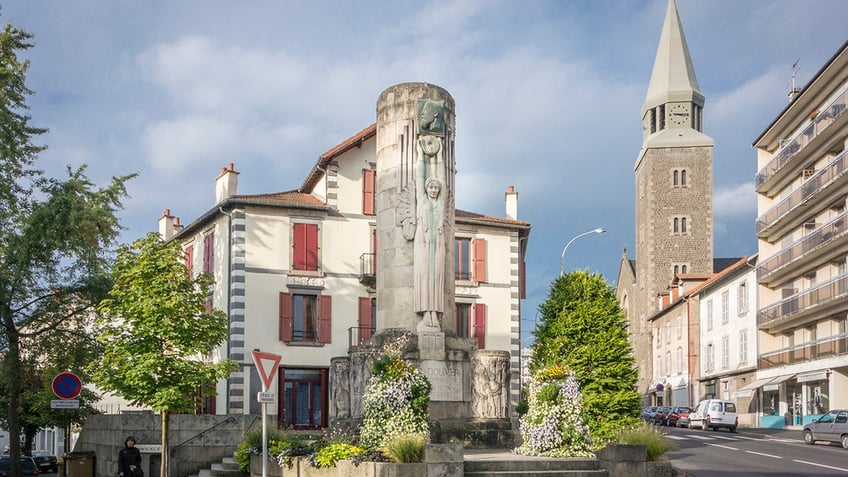 Monument of Paul Doumer and the Sacre Coeur church in Aurillac, France