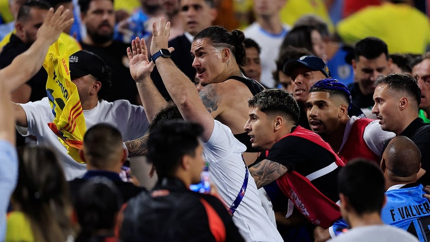 Uruguay players confront Colombian fans in stands