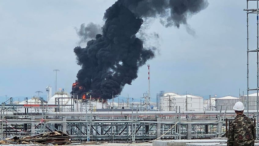 Black smoke billows after an explosion at gas storage tanks in an industrial area in Thailand