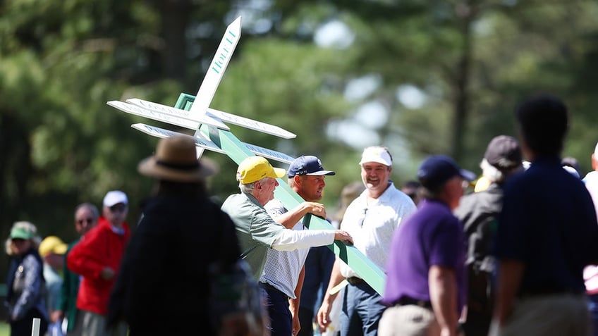 Bryson DeChambeau with sign