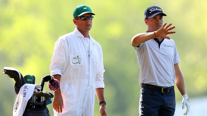 Justin Thomas talks with caddie