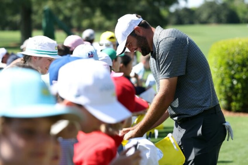 Top-ranked Scottie Scheffler, the 2022 Masters winner, signs autographs ahead of a final p