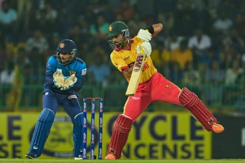 Zimbabwe's Sikandar Raza (R) plays a shot during the first Twenty20 international cricket match between Zimbabwe and Sri Lanka