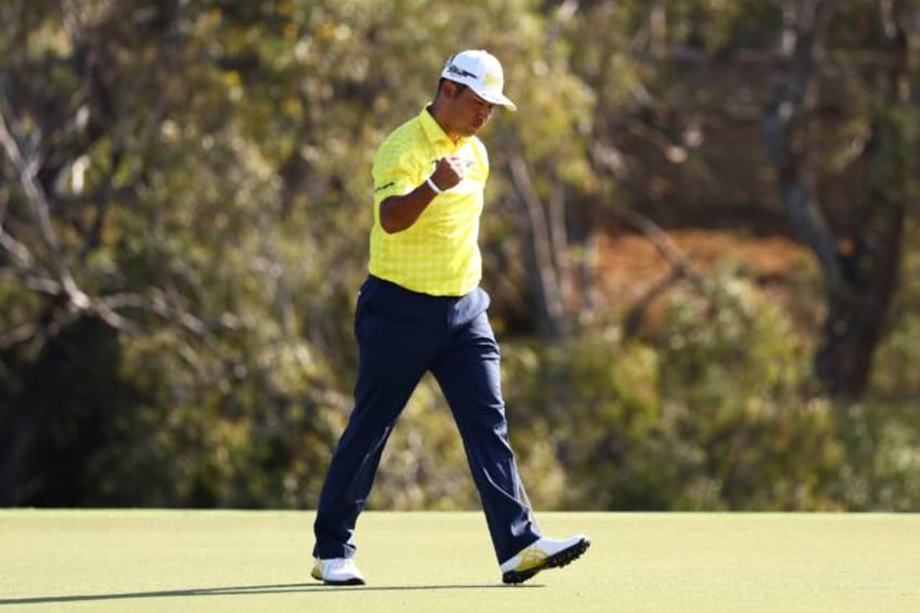 Hideki Matsuyama of Japan celebrates on the 18th green after making a birdie putt to win T