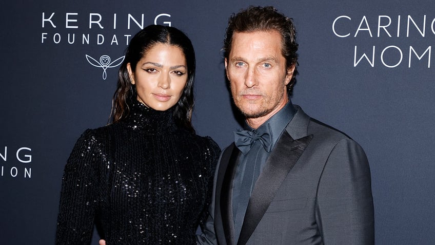 Camila Alves McConaughey in a sparkly turtleneck dress appears on the carpet with husband Matthew McConaughey in a dark grey suit