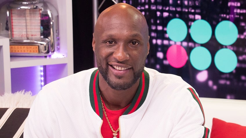 Lamar Odom sports white jacket with red shirt