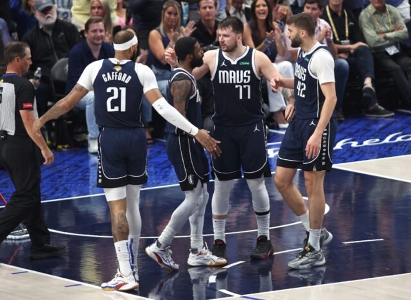 Dallas stars Kyrie Irving and Luka Doncic react during the second quarter of their victory