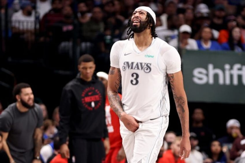 Anthony Davis of the Dallas Mavericks leaves the court with an adductor muscle injury duri