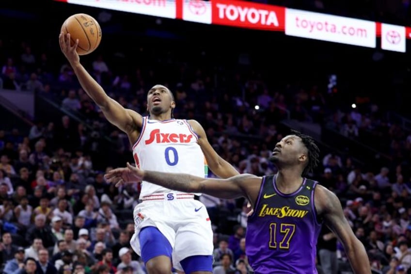 Tyrese Maxey of the Philadelphia 76ers goes in for a layup against Dorian Finney-Smith in