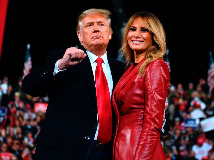 US President Donald Trump stands with First Lady Melania Trump at the end of a rally to su