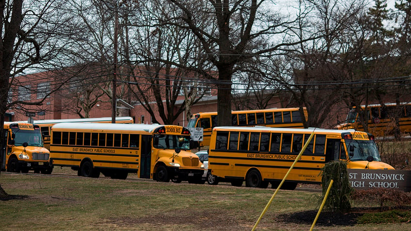 School buses drive from the campus of East Brunswick High School after the school day on February 22, 2018, in East Brunswick, New Jersey.