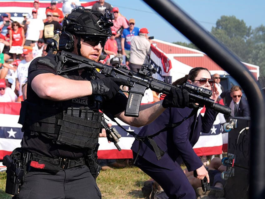 U.S. Secret Service agents surround the stage as other agents cover Republican presidentia