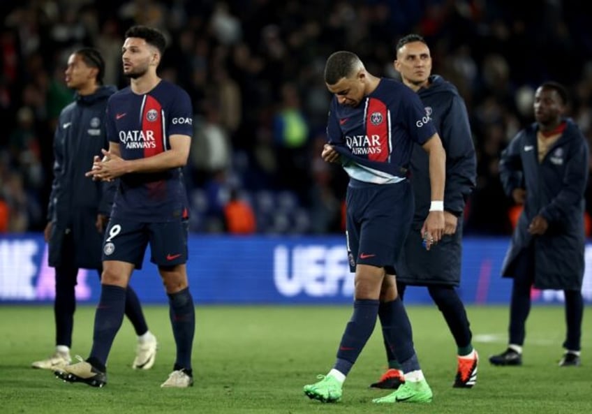 Kylian Mbappe walks off the pitch with PSG teammates after the French side's 3-2 defeat by