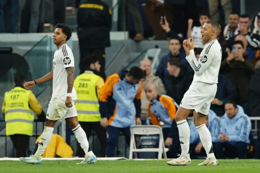 Real Madrid's French forward Kylian Mbappe (R) celebrates scoring the opening goal against