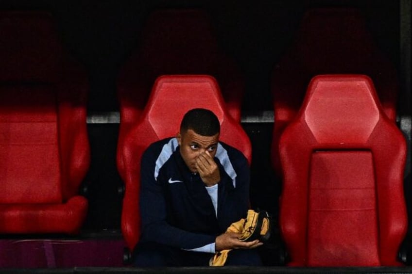 Kylian Mbappe, who broke his nose in France's opening game of Euro 2024, watched from the