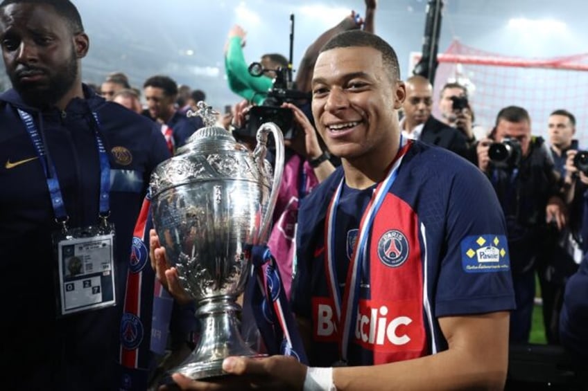 Kylian Mbappe parades the trophy after PSG beat Lyon 2-1 in Saturday's French Cup final