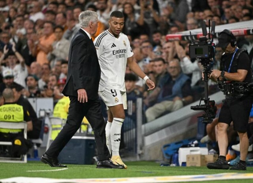 Real Madrid coach Carlo Ancelotti (L) said Kylian Mbappe (R) 'seems unaffected' after Swed