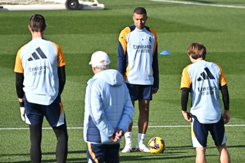 Real Madrid forward Kylian Mbappe (L) takes part in a training session ahead of the Getafe