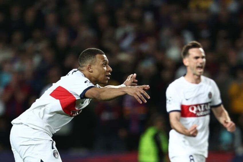 Paris Saint-Germain striker Kylian Mbappe celebrates converting his penalty against Barcel