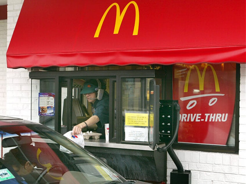 CHICAGO - DECEMBER 8: A McDonald's worker delivers an order to a drive-thru customer Decem