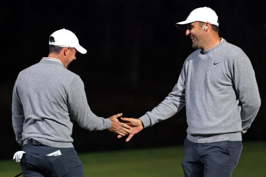 Rory McIlroy, left, and Scottie Scheffler of the PGA Tour celebrate in the Showdown, in wh