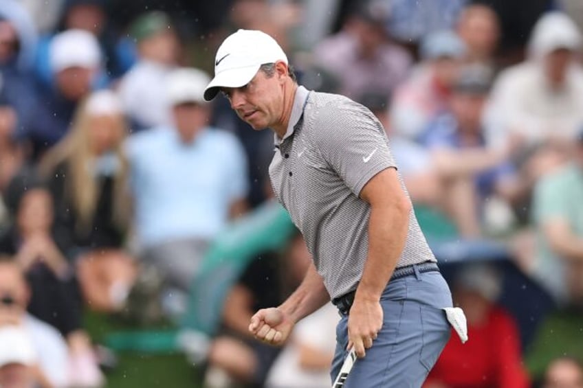 Rory McIlroy of Northern Ireland pumps his right fist after making a birdie putt at the 11