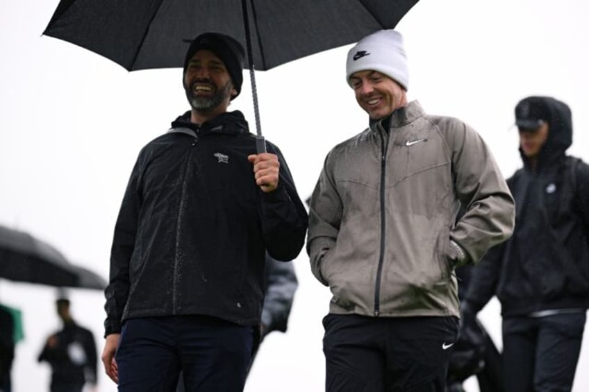 Four-time major winner Rory McIlroy of Northern Ireland, right, and Donald Trump Jr. walk