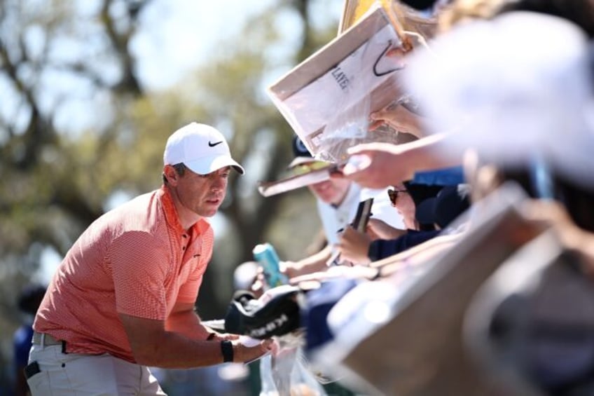 Rory McIlroy signs autographs for spectators at The Players Championship, where he took th