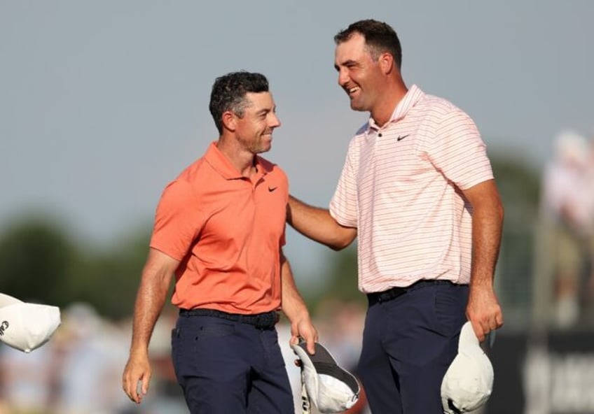 Rory McIlroy, left, speaks with top-ranked playing partner Scottie Scheffler after the fir