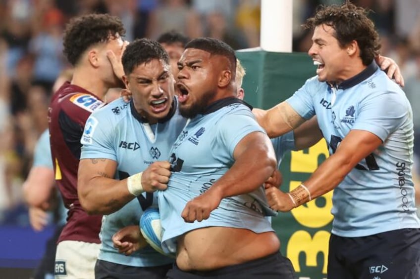 NSW Waratahs' Siosifa Amone (C) celebrates his winning try against the Otago Highlanders