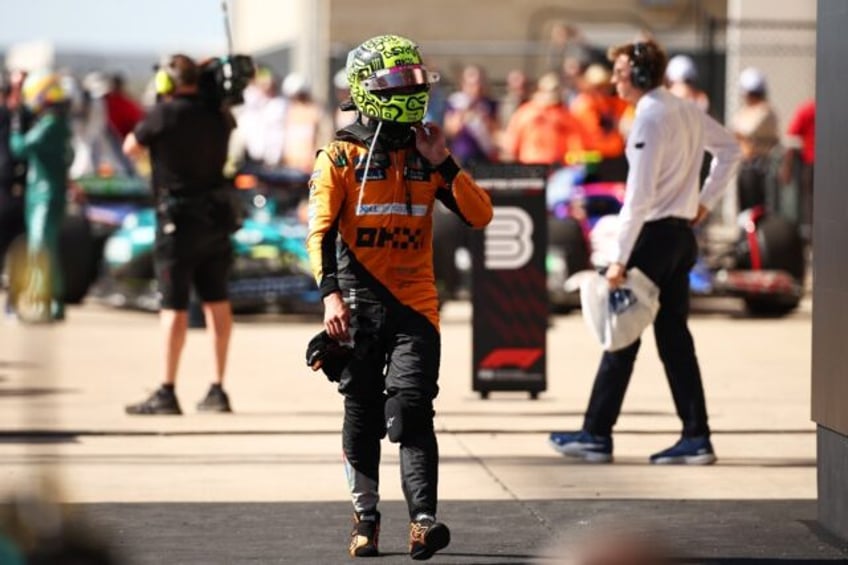 Rueful: Lando Norris of McLaren looks on in parc ferme