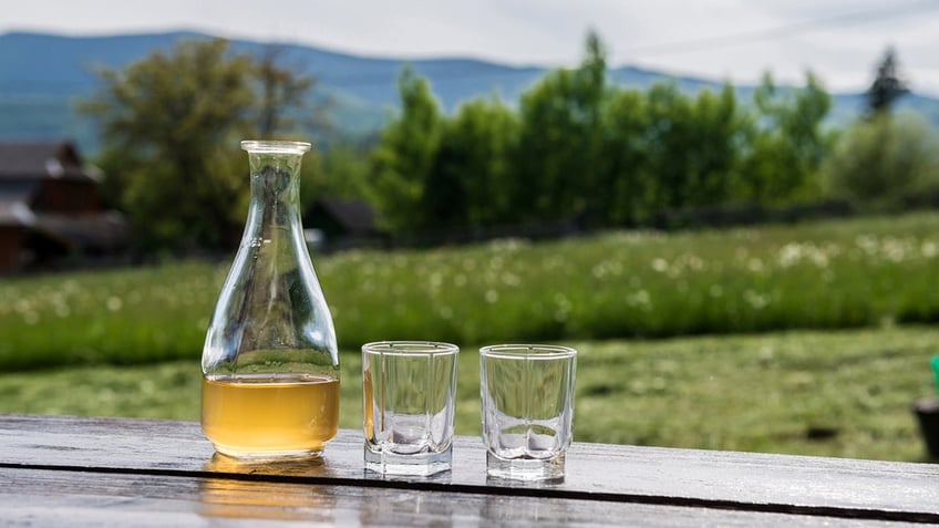 Sweet yellow honey wine mead in beautiful mountain landscape. Ready to drink