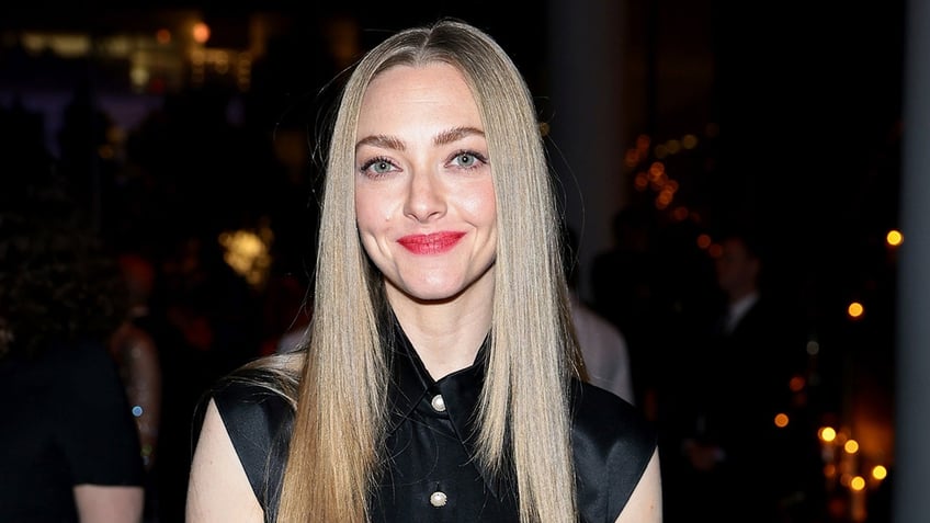 Close up of Amanda Seyfried smiling wearing black