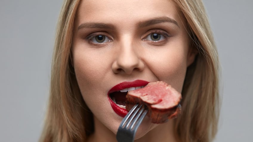 Woman eating steak