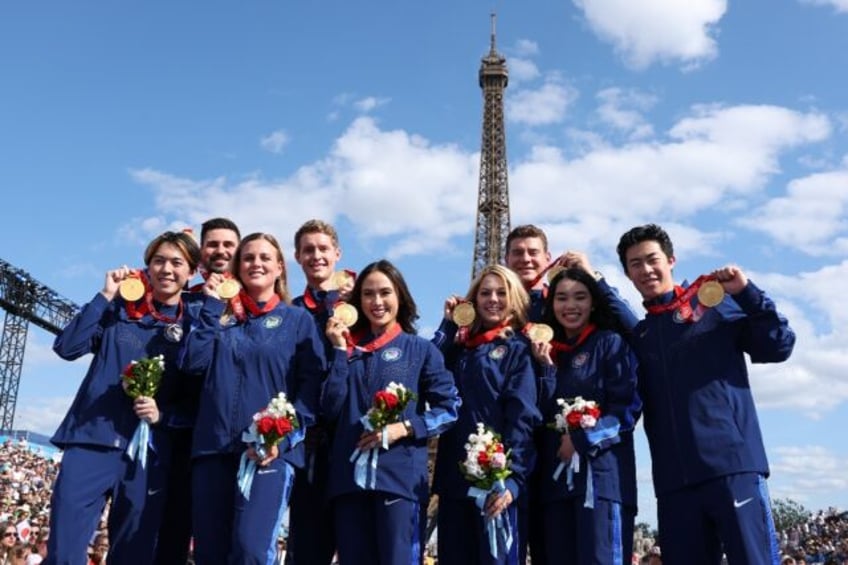 Members of the US figure skating team pose with their medals, following the reallocation o