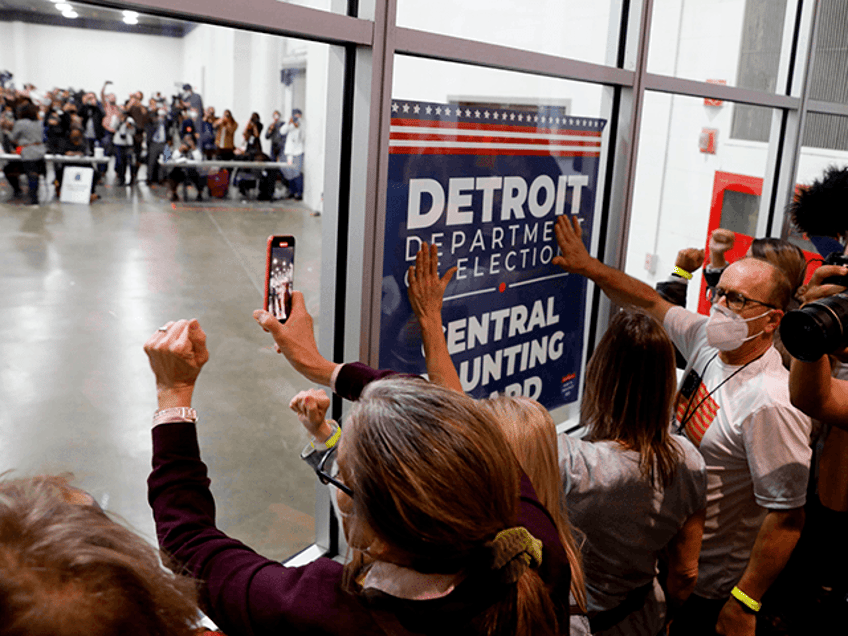 Supporters of US President Donald Trump bang on the glass and chant slogans outside the room where absentee ballots for the 2020 general election are being counted at TCF Center on November 4, 2020 in Detroit, Michigan. - Democratic presidential challenger Joe Biden on November 4 neared the magic number …